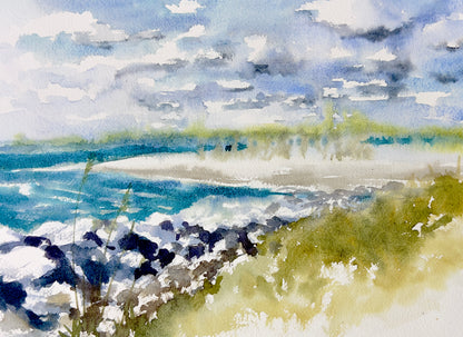 original watercolor painting of the turquoise water at the inlet with rocks, light green plants and clouds in the blue sky.